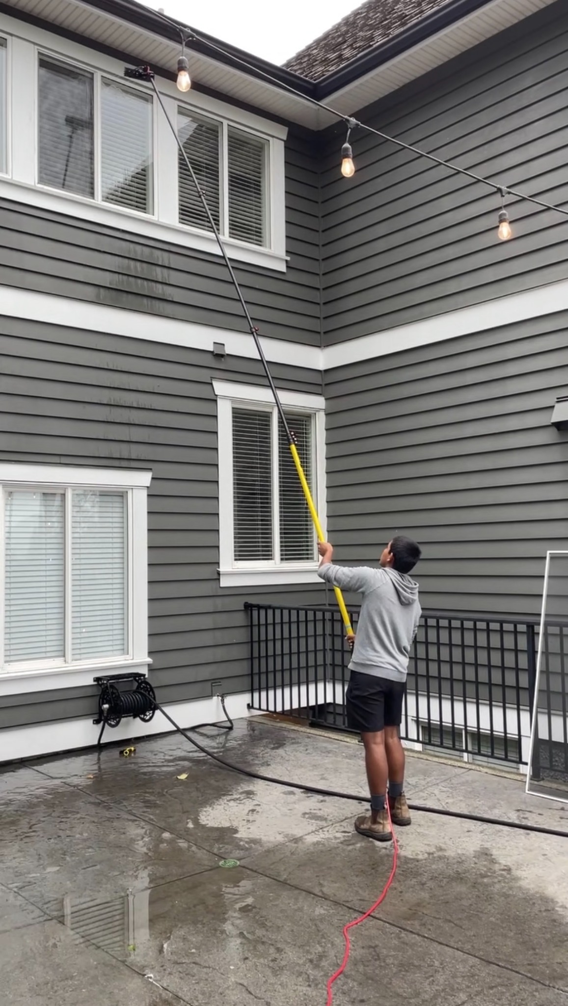 Water-fed pole window cleaning on a residential patio